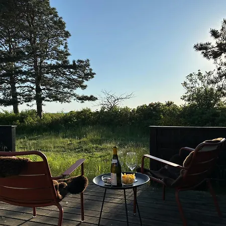 Log With View Of Meadow And Sea *